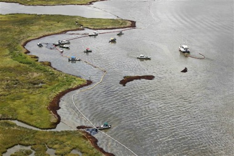 Boats are seen along the oil damaged shoreline in the northern reaches of Barataria Bay, La., on Thursday.